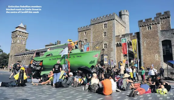 ??  ?? > Extinction Rebellion members blocked roads in Castle Street in the centre of Cardiff this week