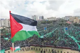  ?? — AFP ?? Hamas supporters take part in a rally marking the 30th anniversar­y of the founding of the Islamist movement, in Gaza City, on Thursday.