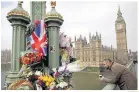  ?? Dan Kitwood / Getty ?? Flowers on Westminste­r Bridge in memory of those who died