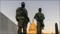  ?? CAROLYN KASTER - THE ASSOCIATED PRESS ?? National Guard stand their posts around the Capitol at sunrise in Washington, Monday, March 8, 2021.