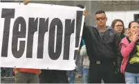  ?? JENS MEYER/ASSOCIATED PRESS ?? Protesters gather for a far-right rally Monday in front of a Karl Marx monument in Chemnitz, Germany. A man has died and two others were injured in an altercatio­n Sunday in the city.