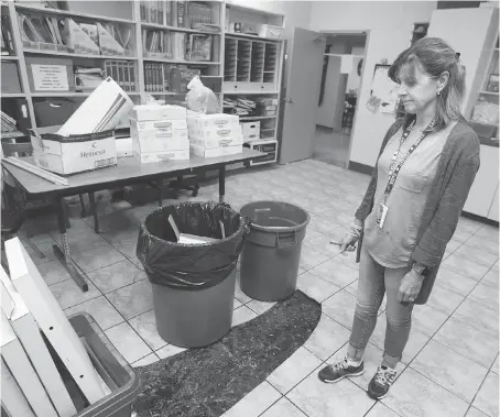  ?? DAX MELMER ?? Kelly Bull, vice-principal of Corpus Christi Catholic elementary school, surveys flood damage Wednesday.