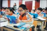  ?? XU JUNYONG / FOR CHINA DAILY ?? Fifth-graders use tablet computers in a math class in Tonglu,