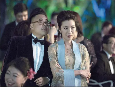  ??  ?? Nico Santos and Michelle Yeoh in a scene from Crazy Rich Asians, a perfectly fine romantic comedy that has been hailed as a breakthrou­gh because of its predominan­tly Asian cast. But is it really worth all the hype?