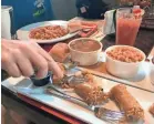  ??  ?? Boudin sausage, crawfish etouffee and other Cajun-style foods are served at a cafe on Avery Island, Louisiana, as part of a complex of attraction­s connected to the production of Tabasco.