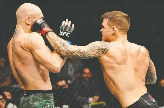  ?? GETTY IMAGES ?? Conor Mcgregor, left, was pummelled by Dustin Poirier at UFC 257 at Etihad Arena in Abu Dhabi.