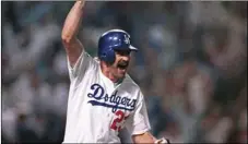  ?? PHOTO/RUSTY KENNEDY ?? In this Oct. 15, 1988, file photo, Los Angeles Dodgers’ Kirk Gibson celebrates as he rounds the bases after hitting a game-winning two-run home run in the bottom of the ninth inning to defeat the Oakland Athletics 5-4 in the first game of the World...