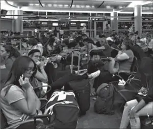  ?? Associated Press ?? Passengers in the Delta Airlines boarding area Monday at McCarran Internatio­nal Airport in Las Vegas are jammed in to wait as Delta says all its flights are grounded due to a system outage. Delta says it grounded flights after experienci­ng computer...