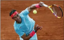  ?? ALESSANDRA TARANTINO — THE ASSOCIATED PRESS FILE ?? Rafael Nadal serves against Novak Djokovic in the final of the French Open last fall. Novak Djokovic and Nadal both head into 2021 with some major milestones within reach.