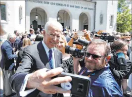  ?? Mic Smith The Associated Press ?? Former Vice President Joe Biden takes a selfie following the April 16 funeral for former U.S. Sen. Ernest “Fritz” Hollings on The Citadel campus in Charleston, S.C.