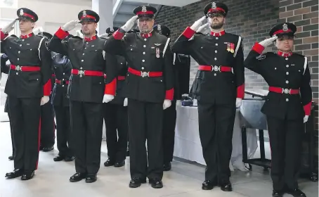  ?? PHOTOS: JASON KRYK ?? The honour guard of the Windsor Police Service salutes during the dedication Friday at St. Clair College of a Herb Gray Parkway tunnel in memory of late Windsor Sr. Const. John Atkinson. Atkinson was shot dead on May 5, 2006, while on duty.