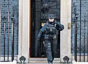 ?? ?? Boris Johnson at No 10 in December 2020, left, and below, a Met police officer at Downing Street yesterday as pressure intensifie­s for the force to open an inquiry into rule-breaking by No 10 staff