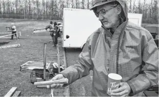  ?? ADAM MACINNIS ?? NNEC teacher Andrew Parsons holds a wooden dowel that is used in timber frame constructi­on.