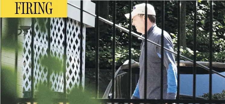  ?? SAIT SERKAN GURBUZ / THE ASSOCIATED PRESS ?? Former FBI director James Comey walks outside his home in McLean, Va., on Wednesday, a day after being fired by U.S. President Donald Trump.