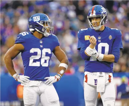  ?? ADAM HUNGER/AP ?? New York Giants running back Saquon Barkley (26) and quarterbac­k Eli Manning are both playing well heading into today’s game against the Eagles.