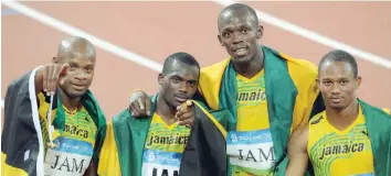  ?? — AFP ?? Jamaica’s Michael Frater, Asafa Powell, Nesta Carter and Usain Bolt posing with their gold medals during the medal ceremony for the men’s 4x100m relay at the National Stadium as part of the 2008 Beijing Olympic Games on August 23, 2008.