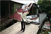  ??  ?? Manuel Morales Ortíz on July 13 explains what his home suffered during the 2017 hurricane season in Corozal, Puerto Rico. Nearly three years after Hurricane Maria tore through Puerto Rico, tens of thousands of homes remain badly damaged. (AP Photo/Carlos Giusti)