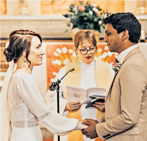  ??  ?? Front-line health workers Jann Tipping and Annalan Navaratnam are married in a special service conducted by the Rev Mia Hilborn at the St Thomas’ Hospital chapel