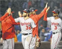  ?? AP PHOTO/NAM Y. HUH ?? Washington Nationals’ Bryce Harper (34) and Michael Taylor (3) celebrate after Game 4 of baseball’s National League Division Series against the Chicago Cubs in Chicago, Wednesday. The Nationals won, 5-0.