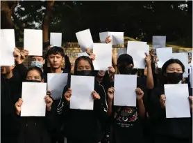  ?? ?? Tibetan Youth Congress (TYC) supporters hold white blank sheets to stage a protest in solidarity with the ongoing White Paper protests in China, in New Delhi on Friday. ANI