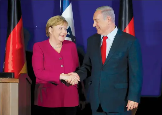  ?? (Marc Israel Sellem/The Jerusalem Post) ?? PRIME MINISTER Benjamin Netanyahu and German Chancellor Angela Merkel share a smile and handshake on her recent visit to Jerusalem.