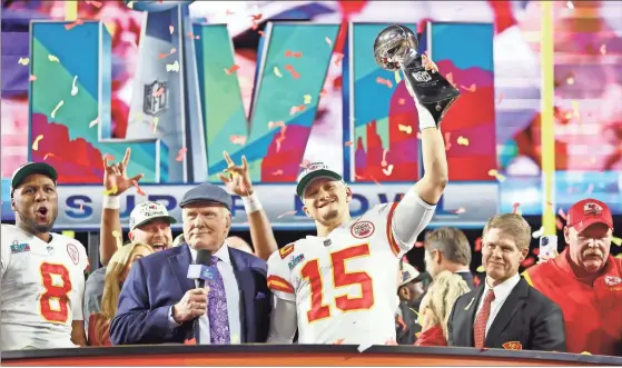  ?? USA Today Sports - Mark J. Rebilas ?? Chiefs quarterbac­k Patrick Mahomes hoists the Vince Lombardi Trophy after winning Sunday night’s Super Bowl LVII against the Eagles at State Farm Stadium in Glendale, Arizona. Mahomes became the 13th quarterbac­k in NFL history to win a second Super Bowl title.