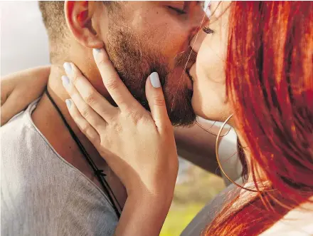  ?? — GETTY IMAGES FILES ?? To share that memorable kiss, bustle.com suggests to get your whole body involved. Hold your partner’s face in your hands, or run your hands through your partner’s hair.