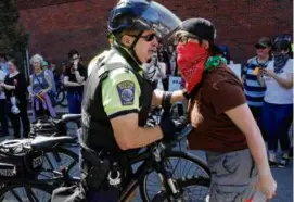  ?? CRAIG F. WALKER/GLOBE STAFF ?? Police Captain John Danilecki confronted a counterpro­tester during a “Straight Pride” parade in Boston on Aug. 31, 2019.