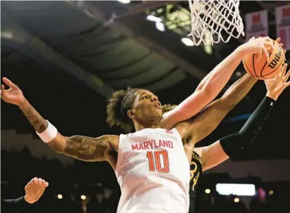  ?? JULIA NIKHINSON/AP ?? Maryland forward Julian Reese battles Northweste­rn center Matthew Nicholson for a loose ball in the second half Sunday.