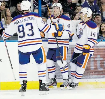  ?? C h r i s O’M e a r a /Ass o c i at e d P r e ss ?? From left, Edmonton forwards Ryan Nugent-Hopkins, Taylor Hall and Jordan Eberle celebrate scoring earlier this season. A reader asks if their high salaries have affected their play.