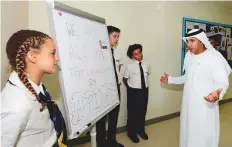  ?? Atiq Ur Rehman/Gulf News ?? Dr Abdullah Al Karam interacts with Safa Community School students during the well-being census event yesterday.