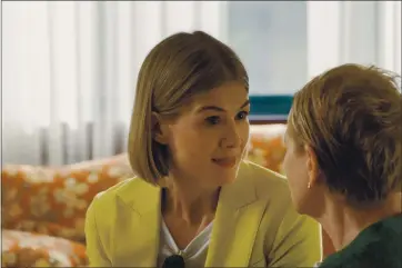  ?? NETFLIX ?? Rosamund Pike stars as a con artist who preys on the elderly in “I Care a Lot” (with Dianne Wiest, right).