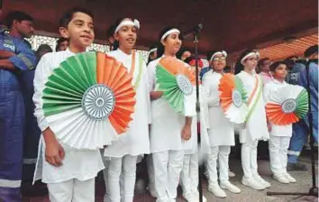  ?? Abdul Rahman/Gulf News ?? Students of Indian schools sing the national anthem at a flag-hoisting ceremony at the embassy in Abu Dhabi yesterday morning to mark Republic Day.