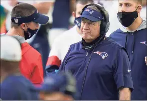  ?? Chris O'Meara / Associated Press ?? New England Patriots head coach Bill Belichick stands on the sidelines during the second half against the Miami Dolphins on Sunday in Miami Gardens, Fla. The Dolphins defeated the Patriots 22-12.