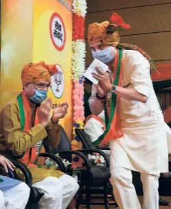  ??  ?? BJP MP JYOTIRADIT­YA SCINDIA greeting
Chief Minister Shivraj Singh Chouhan during the “Virtual Rally” at the party headquarte­rs in Bhopal on July 3.