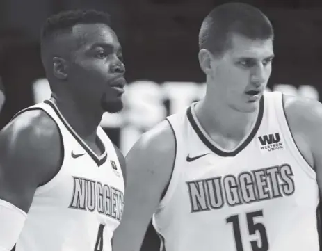  ?? John Leyba, The Denver Post ?? Nuggets forward Paul Millsap, left, and center Nikola Jokic have just gotten started getting used to playing together. Nuggets coach Michael Malone believes it might be a couple of months before the two players are fully in sync.