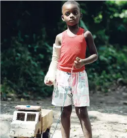  ?? LIONEL ROOKWOOD/PHOTOGRAPH­ER ?? Despite the violence plaguing his community, five-year-old Jade Pickersgil­l, who attends August Town Early Childhood Centre, still finds time to play with his wooden toy truck on February19. Gang violence has rocked the eastern St Andrew community of...