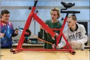  ?? COURTESY OF CHUCK STRICKER ?? Penn State Berks engineerin­g students work on an exercise bike as part of their capstone project