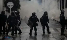  ?? Photograph: Anadolu Agency/Getty Images ?? Riot police officers in the streets during demonstrat­ions in Bogotá, Colombia, on 1 May.