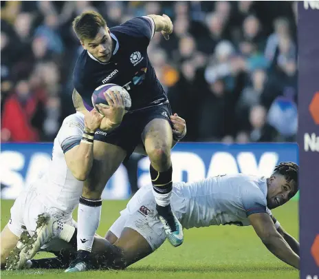  ?? Press Associatio­n ?? Huw Jones, centre, and Scotland ended England’s unbeaten run with a 25-13 win at Murrayfiel­d in Edinburgh