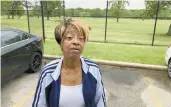  ?? ?? Carolyn Phillips stands Tuesday outside a building in The Park of River Oaks condominiu­m complex in Calumet City. A fire broke out Monday. and she is one of dozens of residents who were displaced.