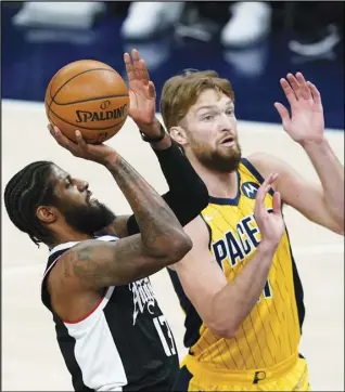  ?? Associated Press ?? RETURN — Los Angeles Clippers’ Paul George (13) puts up a shot against Indiana Pacers’ Domantas Sabonis (11) during the first half of an NBA basketball game on Tuesday in Indianapol­is.