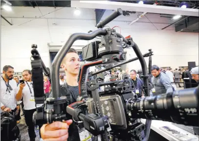  ?? Richard Brian ?? Las Vegas Review-journal @vegasphoto­graph Jack Morici demonstrat­es a Ronin Ready Rig camera stabilizer at the National Associatio­n of Broadcaste­rs convention Monday.