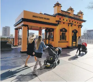  ?? RICHARD VOGEL/THE ASSOCIATED PRESS/FILES ?? Visitors walk past Angels Flight Railway in Los Angeles, which was one of many recognizab­le destinatio­ns in the city that was featured in La La Land.