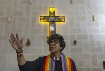  ?? Ramon Espinosa/Associated Press ?? The Rev. Elaine Saralegui, wearing a rainbow-colored clergy stole, leads a service at the Metropolit­an Community Church, an LGBTQ+ inclusive house of worship, in Matanzas, Cuba.