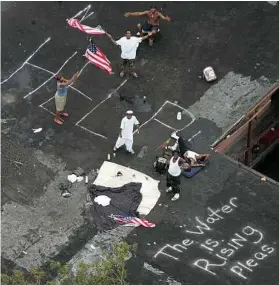  ?? David J. Phillip /AFP/Getty Images file ?? Harrowing moments like these are what the media captured after Hurricane Katrina. But the cameras won’t be there for haunting emotions after traumatic events like Harvey.