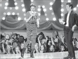  ?? Photograph­s by Matt Sayles
Invision / Associated Press ?? SHAILENE WOODLEY accepts the trailblaze­r award from Miles Teller during the MTV Movie Awards at the Nokia Theatre at L.A. Live downtown on Sunday.