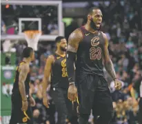  ??  ?? Cavaliers forward LeBron James, right, celebrates a basket during Game 7 of the Eastern Conference finals against the Celtics on Sunday in Boston.