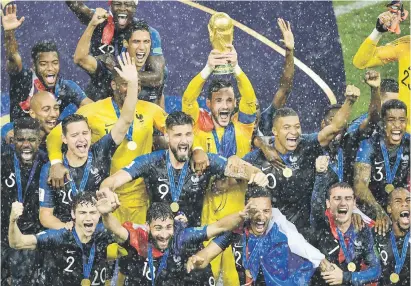  ?? Picture: AFP ?? GOLDEN MOMENT. France captain Hugo Lloris holds the World Cup trophy as he celebrates with his team-mates after beating Croatia in the final on Sunday.