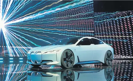  ??  ?? Above: The BMW i-Vision revealed in 2017 provides some clues to the 2021 i4. Left: BMW increased its research and developmen­t expenditur­e in 2017 to €6.11bn particular­ly in areas of battery and electric drive technology.